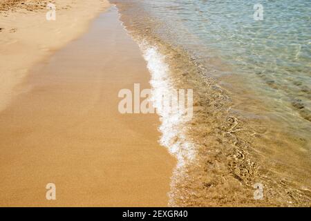 Mesmerizing shot of soft waves on a sandy beach Stock Photo