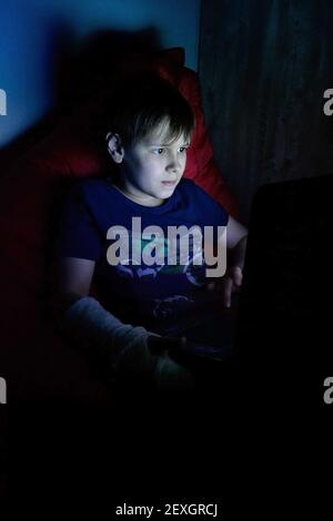 portrait of boy using laptop while sitting on bag chair Stock Photo