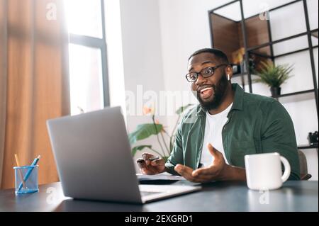 Distance learning at home, online working. African American guy student or freelancer uses a laptop for learning or working, having video conference Stock Photo