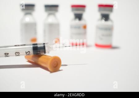 Uncovered syringe and vaccine ampules or glass vials Stock Photo