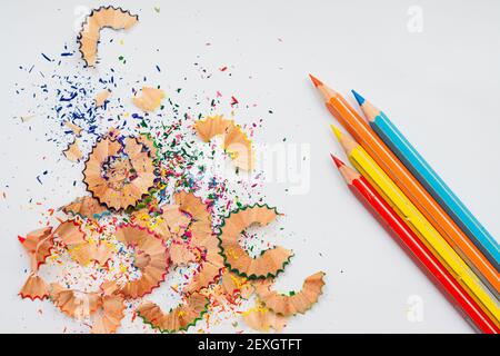 Coloured pencil shavings and pencils on the white background Stock Photo