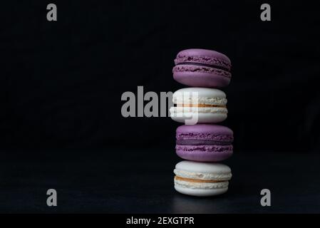 Macarons stacked. Colorful macaroons on dark background Stock Photo