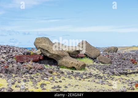 Fallen toppled moai (statues) and pukao (topknots) at Ahu Akahanga on the rocky, rugged south coast of Easter Island (Rapa Nui), Chile Stock Photo