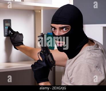 The burglar wearing balaclava mask at crime scene Stock Photo