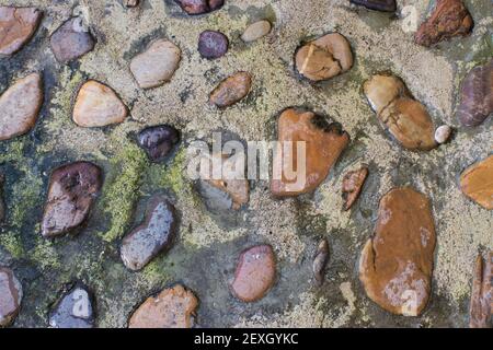 Abstract texture of stones, moss and grass. Cobbled floor Stock Photo