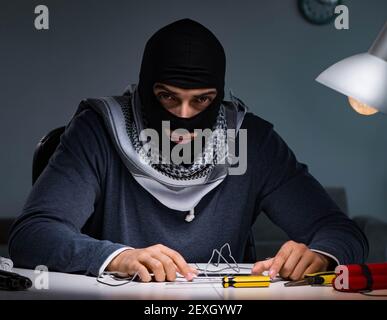 The terrorist bomber preparing dynamite bomb Stock Photo