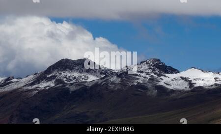 Snowy Andes Mountain range peak with hills beside in cusco Peru Stock Photo