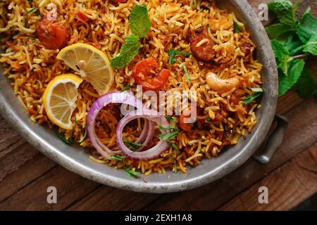 Homemade Prawn Shrimp biryani served with Yogurt Raita and beet pickle Stock Photo