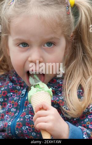 Cute little girl eating ice cream Stock Photo