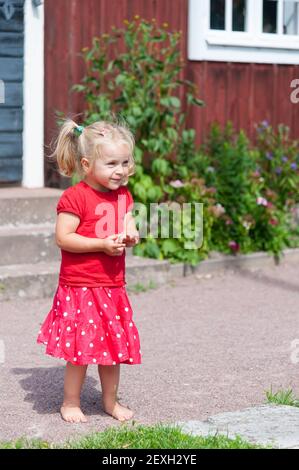 Cute little girl in red summer dress Stock Photo