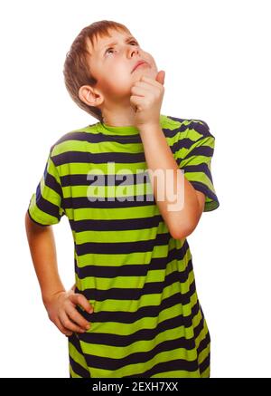 Child boy teen blonde in striped T-shirt scratching his head loo Stock Photo