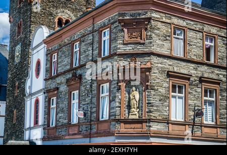 statue of Archangel Michael as a warrior saint slaying a dragon at a corner niche next to the Parish Church of St. Michael in Bernkastel, Bernkastel-K Stock Photo