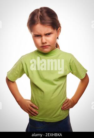 Angry evil girl shows fists experiencing anger emotions Stock Photo