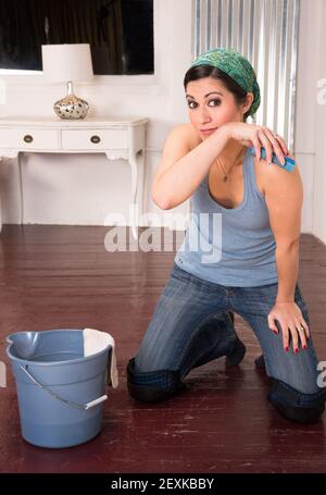 Adorable Housewife Maid Doing Cleaning Chores Scrubbing Floor Hands Knees Stock Photo