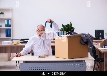 Old employee being fired from his work Stock Photo