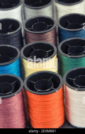 Accessories for using in sewing and needlework. Spools of colorful thread Stock Photo