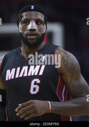 Miami Heat's LeBron James adjusts his protective mask during the first half  of an NBA basketball game in Miami, Monday, March 3, 2014 against the  Charlotte Bobcats. (AP Photo/J Pat Carter Stock