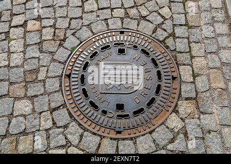 Dresden, Germany, April 18, 2018: Manhole cover made of cast iron of the city sewer system of Dresden. Stock Photo