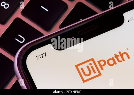 The UiPath logo is seen on an iPhone when the UiPath Orchestrator app is launched. The app manages, controls and monitors UiPath Robots that run ... Stock Photo