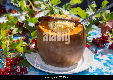 Dairy millet porridge baked in  pumpkin Stock Photo