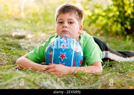 The boy with the ball on the nature Stock Photo