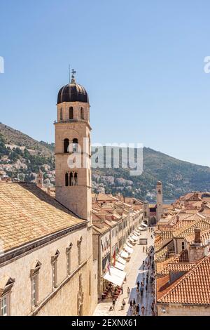 Dubrovnik, Croatia - Aug 22, 2020:Stradun street view of Franciscan church bell tower in morning sunrise in morning Stock Photo