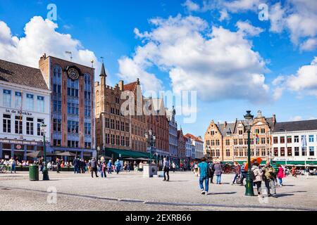 25 September 2018: Bruges, Belgium - Tourists in Markt Square, the main square or plaza of the city, full of beautiful historic buildings, on a fine s Stock Photo