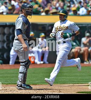 Oakland Athletics' Yoenis Cespedes, right, celebrates his solo home run  with teammate Josh Reddick (16) during the fourth inning of the second game  of a doubleheader baseball game against the Seattle Mariners