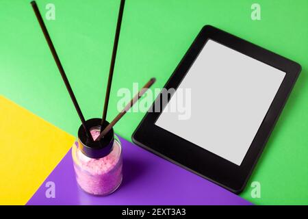 E book reader and aroma diffuser with crystals on yellow backgrond for relaxing and meditation reading meaning and keep calm Stock Photo