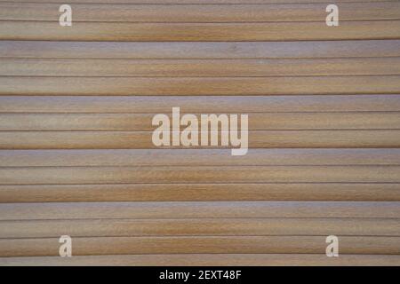 Vinyl siding with wood texture imitation, dark brown color, plastic wall, door of a garage, abstract background with horizontal tiles Stock Photo