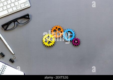 Working gears cogwheels mechanism on working place, ofiice table. Top view Stock Photo