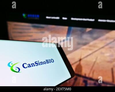 Smartphone with logo of Chinese vaccine company CanSino Biologics Inc. (CanSinoBIO) on screen in front of web page. Focus on center of phone display. Stock Photo