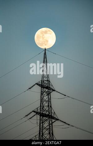 Full moon, high voltage pylon, transmission line pylon, Germany, Stock Photo