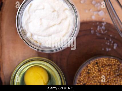 Homemade mayonnaise. Ingredients for mayonnaise oil, egg, and mustard. Stock Photo