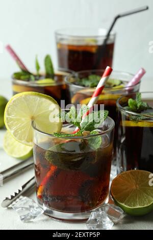 Glasses of Cuba Libre on white textured table Stock Photo