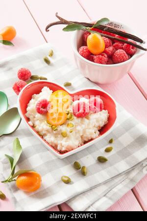 Rice pudding with raspberries and pistachio Stock Photo - Alamy