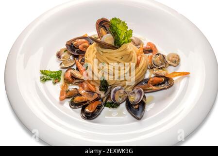 pasta seafood, italian spaghetti with clams mussels and parsley in the white plate isolated on the white Stock Photo