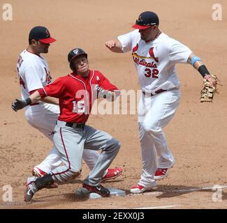 Washington Nationals' Matt Adams, right, celebrates his three-run home run  as Arizona Diamondbacks catcher Caleb Joseph, center, and umpire home plate  Sean Barber (29) look on during the third inning of a