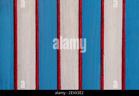 Red, white and blue stripes painted on old wood background. Stock Photo