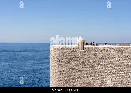 Dubrovnik, Croatia - Aug 22, 2020: Tourists on top of Fort St. Margaret city wall in old town in summer Stock Photo