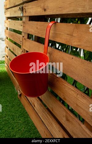 Red Pot Hanging on a Wooden Pallet Background in La Paz, Bolivia Stock Photo