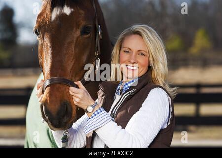 Blonde Model With Horses Stock Photo
