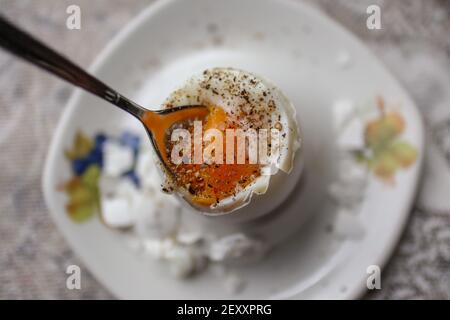 for breakfast with undercooked eggs, salt and pepper Stock Photo