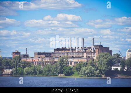 Old industrial building on the river bank Stock Photo