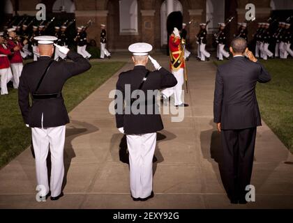 From left, the Commanding Officer of Marine Barracks Washington (MBW) Col. Christian G. Cabaniss; the Evening Parade host, Commandant of the Marine Corps Gen. James F. Amos; and the parade guest of honor, President of the United States Barack H. Obama, stand for the pass in review during the Evening Parade at Marine Barracks Washington, Washington, D.C., June 27, 2014. The Evening Parades are held every Friday night during the summer months. (Photo by Cpl. Tia Dufour, U.S. Marine Corps/DoD/Sipa USA)
