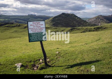 Warning sign on the edge of a rifle range at Thorpe with Thorpe Cloud in the background, Peak District National Park, Derbyshire Stock Photo