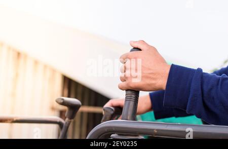 A man hand is controlling a backhoe, building contractor. Stock Photo