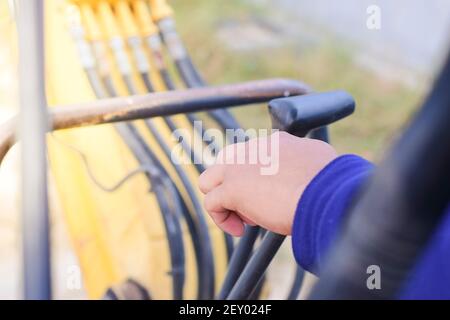 A man hand is controlling a backhoe, building contractor. Stock Photo