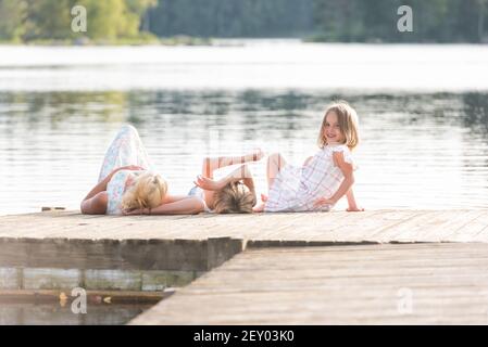 Family relaxing on a boat dock Stock Photo