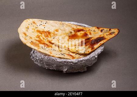 Indian cuisine Tandoori Roti also served in basket including chapati, flatbread, naan or nan bread on wooden background Stock Photo